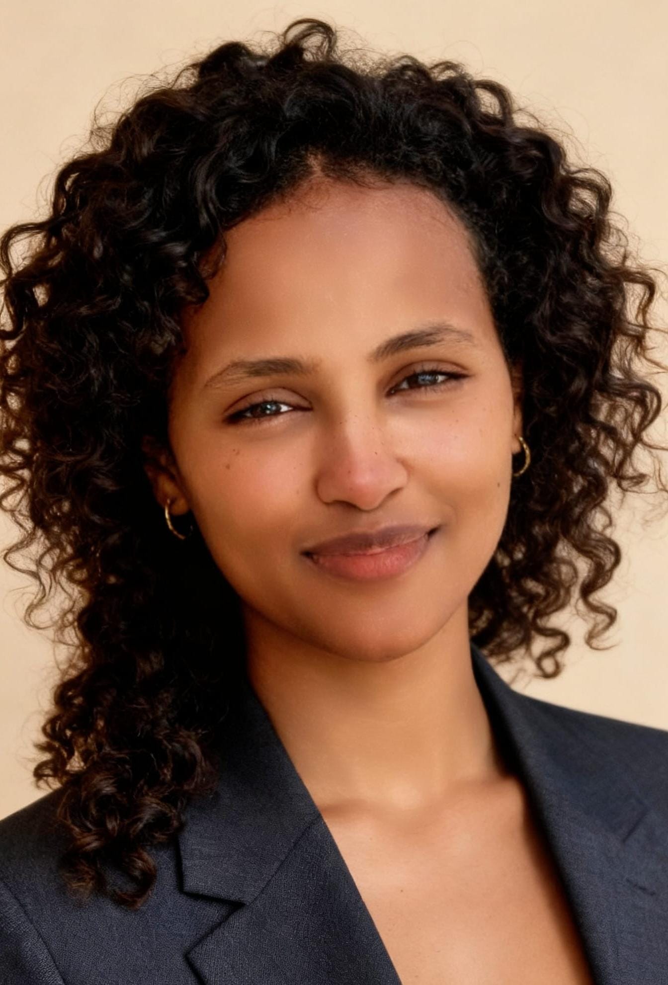 Professional portrait of Melat in a dark blazer